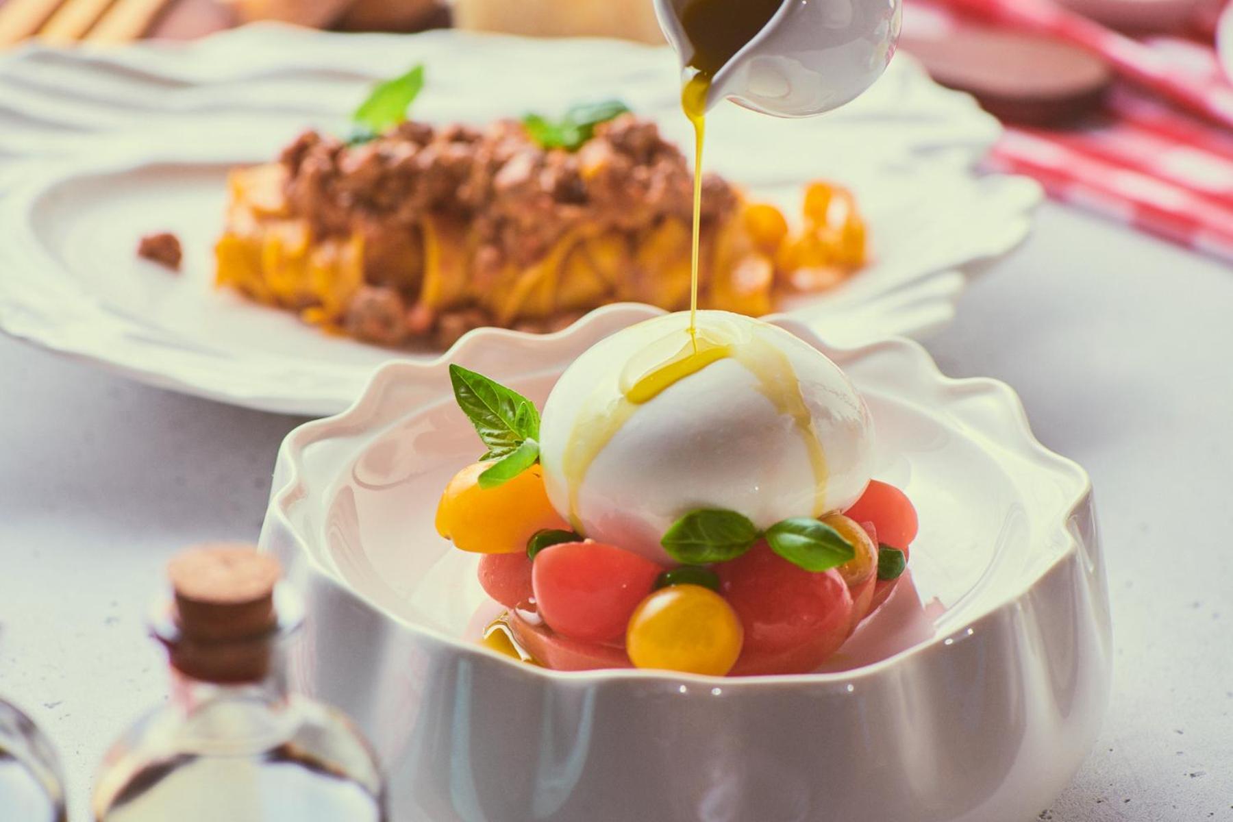 Five Jumeirah Village Дубай Экстерьер фото A salad being drizzled with olive oil